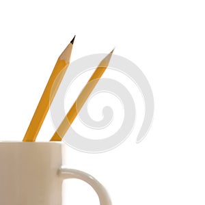 Pencils in coffee cup.