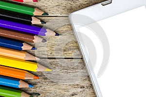 Pencils color and smart phone on wood background