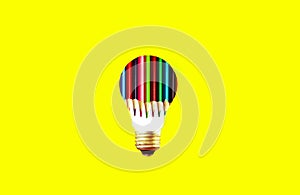 Pencils inside lamp bulb on the yellow background. New idea concept. School advert