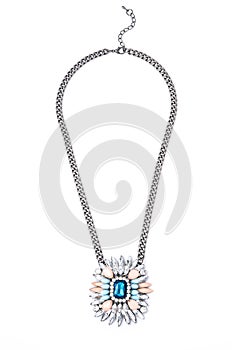 Pendant with flower and blue gem  on a white background