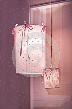 Pendant lamp, chandelier in the children`s bedroom in pink colors for a little princess.