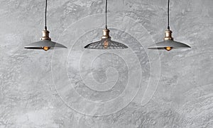 Pendant lamps in loft style against rough wall with gray cement