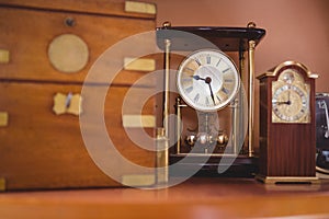 Pendulum clock watch on table