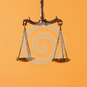 Pendulum scales over an orange background with copyspace