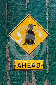 Penguin sign on wooden fence