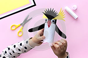 Penguin toy making from colored paper and a roll of toilet paper. Art project. Step by step instruction.