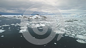 Penguins jumping in Antarctica ocean. Aerial shot.