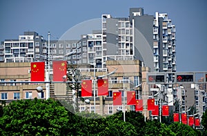 Pengzhou, China: Chinese Flags and Luxury Apartment Buildings