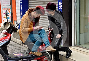 Pengzhou, China: Teens Checking Their Cellphones