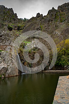 Penha Garcia historic village waterfall and Pego river beach on a cloudy day, in Portugal