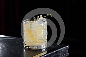 Penicillin cocktail on a bar desk. black background.