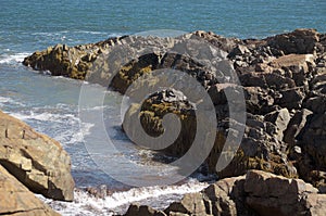 Peninsula of rock jutting out from shore into atlantic ocean