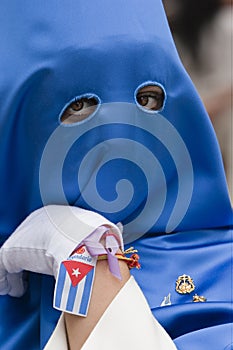 Penitent with caperuz blue of penetrating look and nice eyes during a procession of Holy Week
