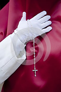 Penitent with a rosary in his hand in a procession