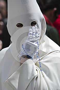 Penitent with a rosary in his hand photo