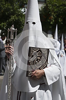 Penitent with the rule book governing the brotherhood