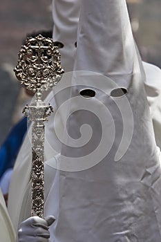 Penitent with staff of silver during a procession of holy week