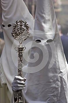 Penitent with staff of silver during a procession of holy week