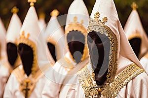 Penitents in traditional robes during an Easter Holy Week procession. photo