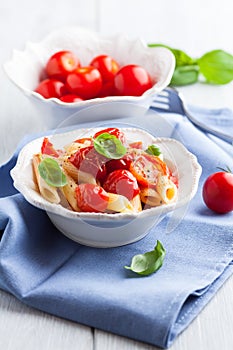 Penne pasta with cherry tomatoes and basil