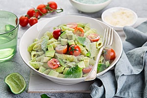 Penne pasta with creamy avocado sauce and tomatoes