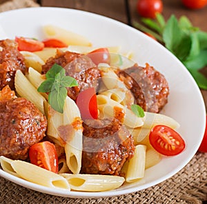 Penne pasta with meatballs in tomato sauce