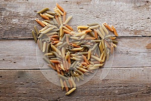 Penne pasta on a wooden background