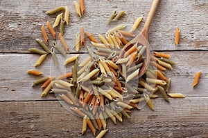 Penne pasta on a wooden background