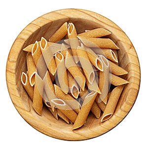 Penne pasta in a wooden bowl isolated on white background. Top view