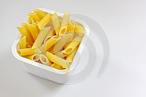 Penne rigate pasta in the plastic box