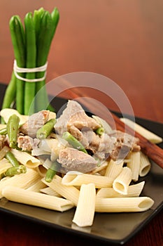 Penne rigate with pork and green beans photo