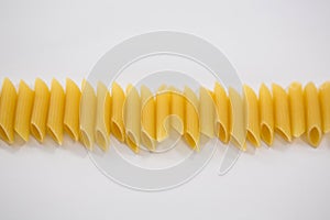 Pennette pasta arranged in a row