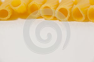 Pennette pasta on white background