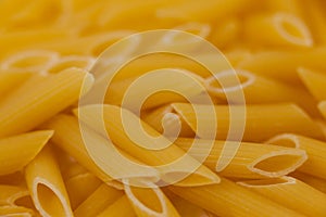 Pennette pasta on wooden surface