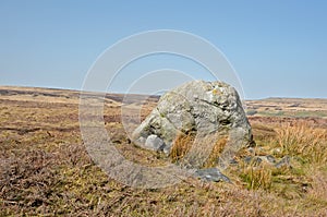 Pennine landscape with large old boulder or standing stone on midgley moor in west yorkshire