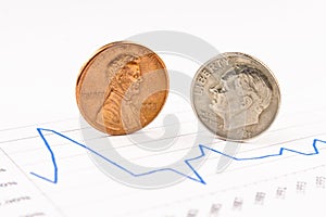Penny and dime coins standing on chart photo