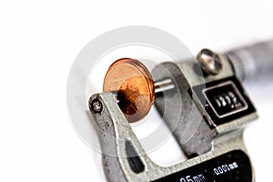 Penny in a micrometer guage to measure thickness photo