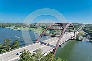 Pennybacker Bridge over Colorado river and Hill Country landscape in Austin