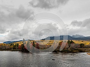 Penobscot River Calmly Flows Below a Cloudy Mount Katahdin