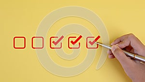 pens to tick the correct sign mark in the checkbox for the quality document control checklist and business approves project