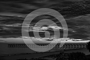 Pensacola Beach pier at sunset black and white