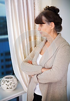 Pension age good looking woman next to window