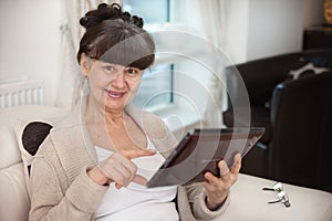 Pension age good looking woman searching in internet