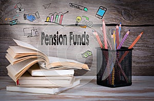 Pension Funds Concept. Stack of books and pencils on the wooden table.