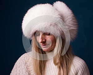 Pensionary woman in warm winter fur hat. Feelings concept