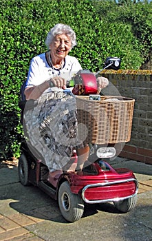 Pensioner demonstrating mobility scooter power chair invalid freedom electric battery photo