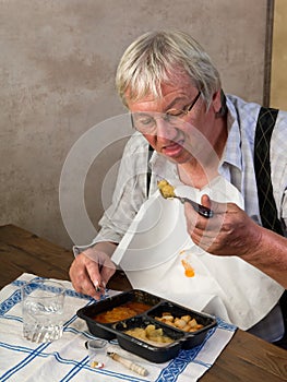 Pensioner eating alone