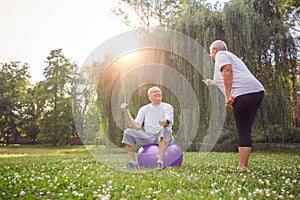 Pensioner family couple exercising outdoors. Concept of healthy