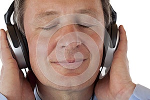 Pensioner with headphones listening to mp3 music