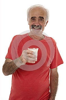 Pensioner holding glass of milk